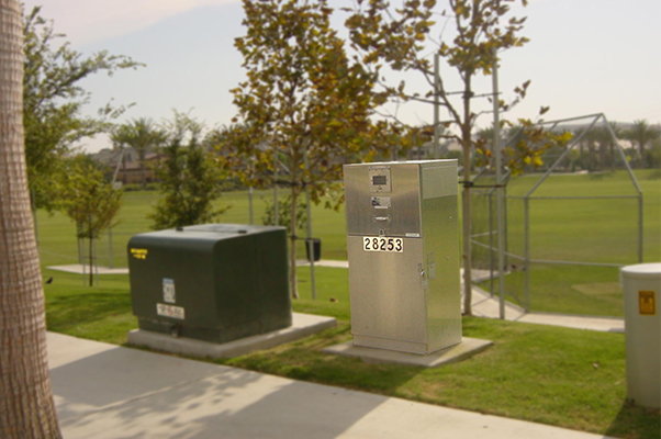 A Milbank enclosed control pedestal at a park provides power for the lighting of oudoor athletic fields.