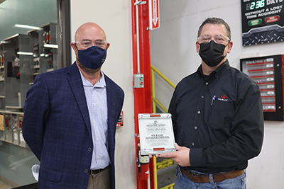 KC Plant Manager Jeff Caudle accepts a safety award for Milbank.