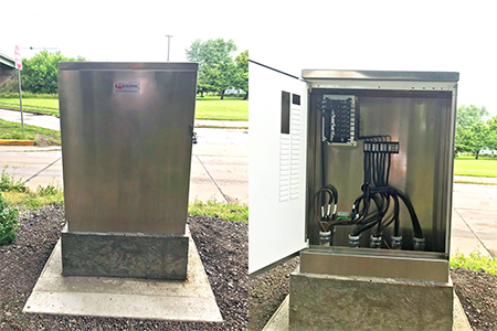 On the left, the exterior of the new cabinet mounted on a concrete base and on the right, the interior of the cabinet, showing circuitry and extra room for additional components.